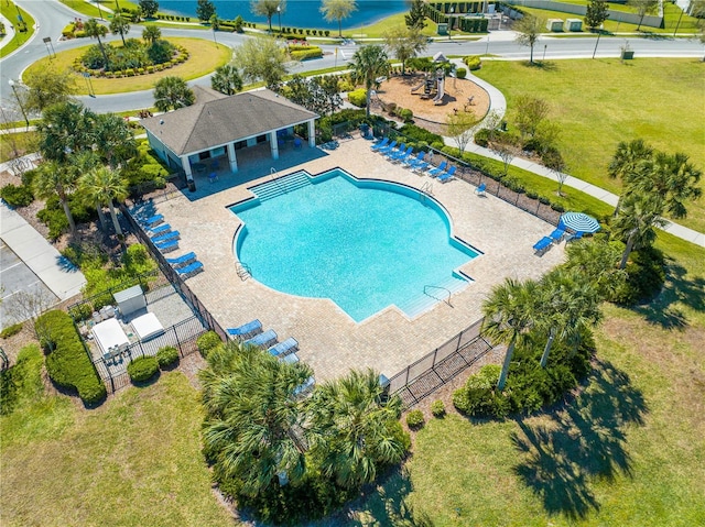 community pool with a yard, fence, and a patio