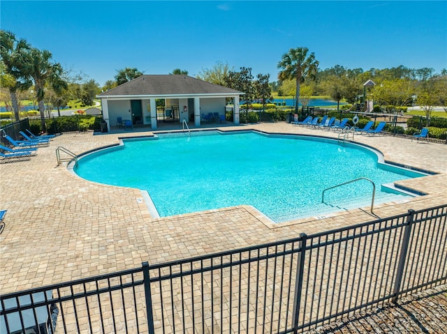 community pool featuring a patio area and fence