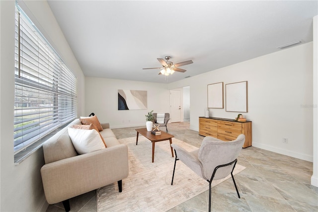 living room with ceiling fan, visible vents, and baseboards