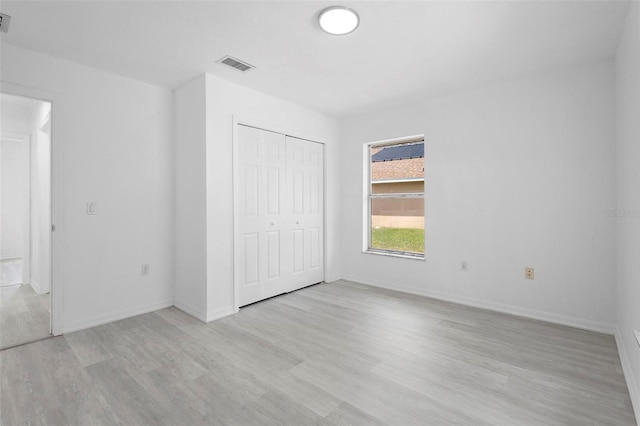 4717 Shad Dr, Sebring, FL 33870 - unfurnished bedroom featuring a closet, light wood-type flooring, visible vents, and baseboards