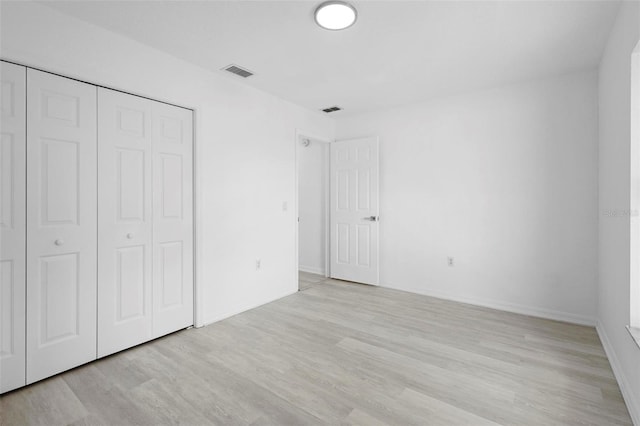 4717 Shad Dr, Sebring, FL 33870 - unfurnished bedroom with a closet, wood finished floors, and visible vents