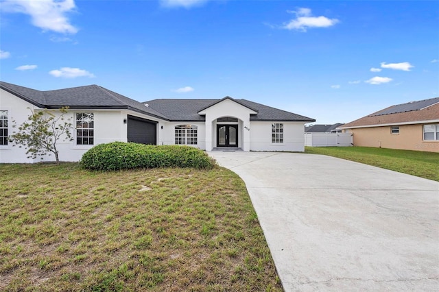 4717 Shad Dr, Sebring, FL 33870 - ranch-style home featuring a garage, driveway, french doors, stucco siding, and a front lawn