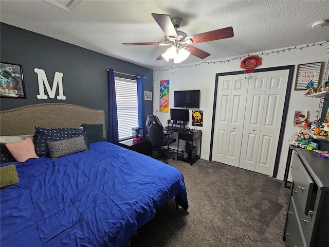 carpeted bedroom featuring a closet, ceiling fan, and a textured ceiling