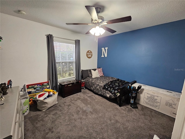 carpeted bedroom with ceiling fan and a textured ceiling