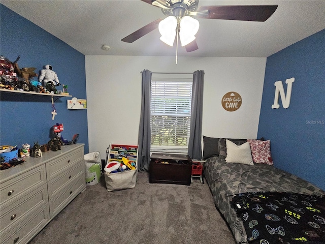 bedroom with a ceiling fan, carpet flooring, and a textured ceiling