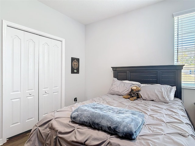 bedroom with a closet and wood finished floors