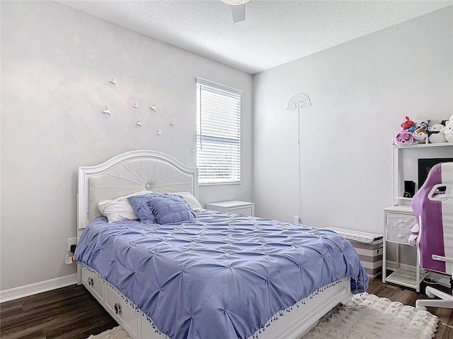 bedroom with a textured ceiling, wood finished floors, a ceiling fan, and baseboards