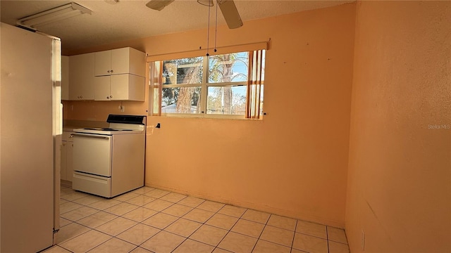 kitchen with a ceiling fan, light tile patterned floors, white electric range, and white cabinetry