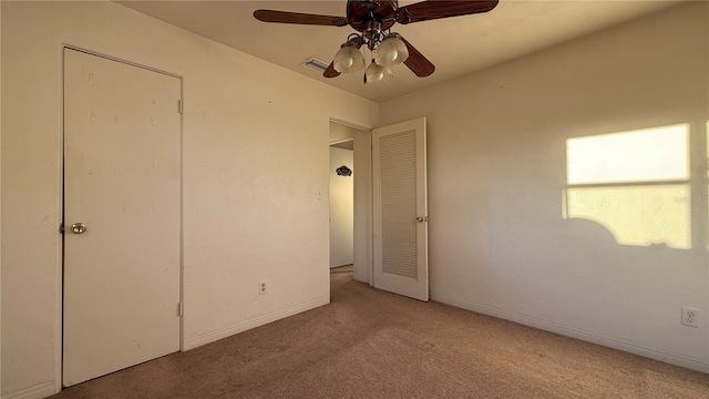 unfurnished bedroom with light carpet, ceiling fan, and baseboards