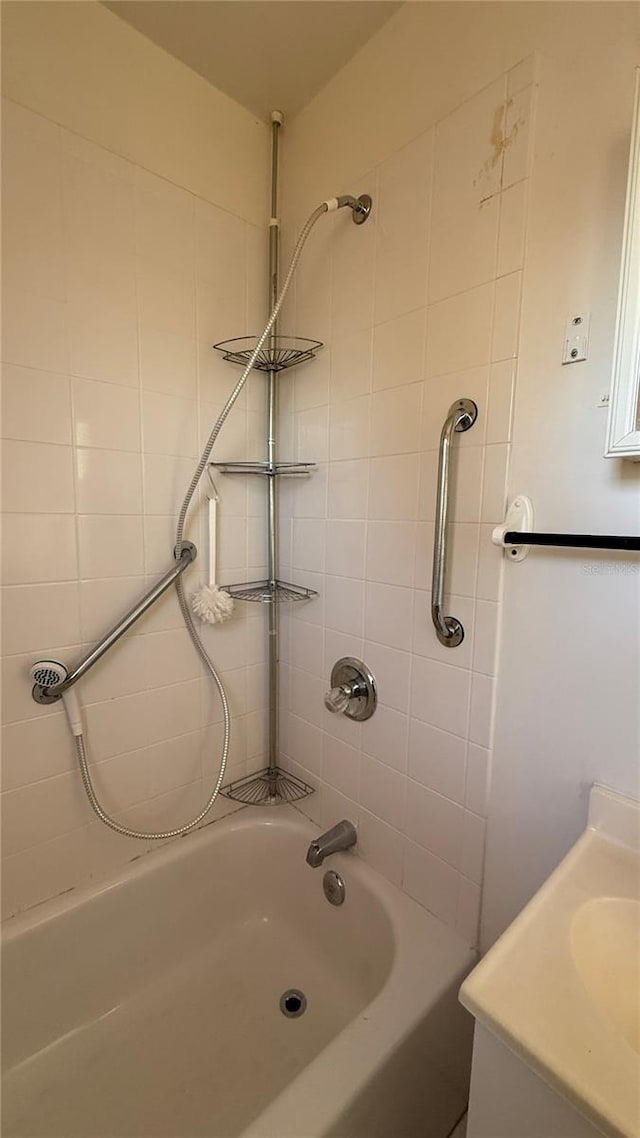 bathroom with tub / shower combination and a sink