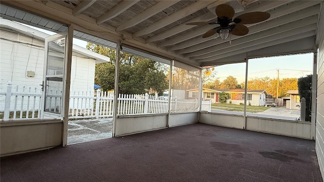 unfurnished sunroom with a ceiling fan and vaulted ceiling