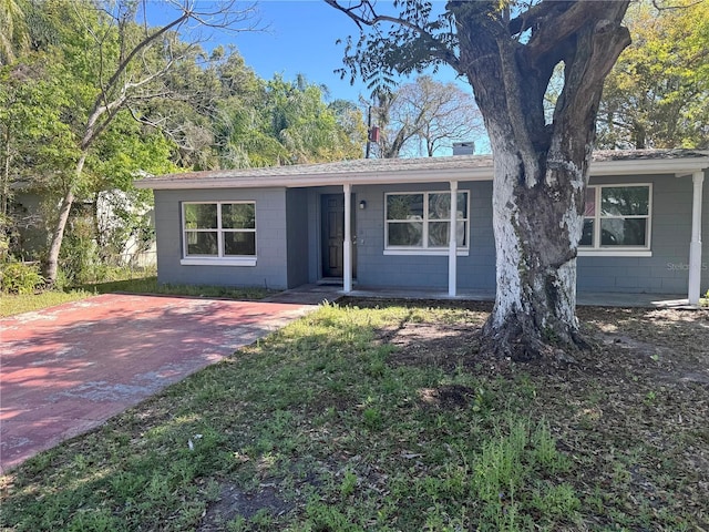 ranch-style house with concrete block siding