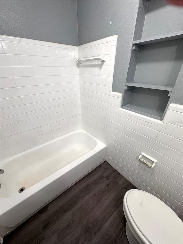 full bathroom featuring tile walls, toilet, and wood finished floors