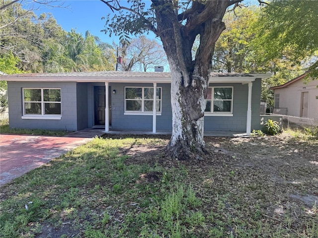 single story home featuring concrete block siding