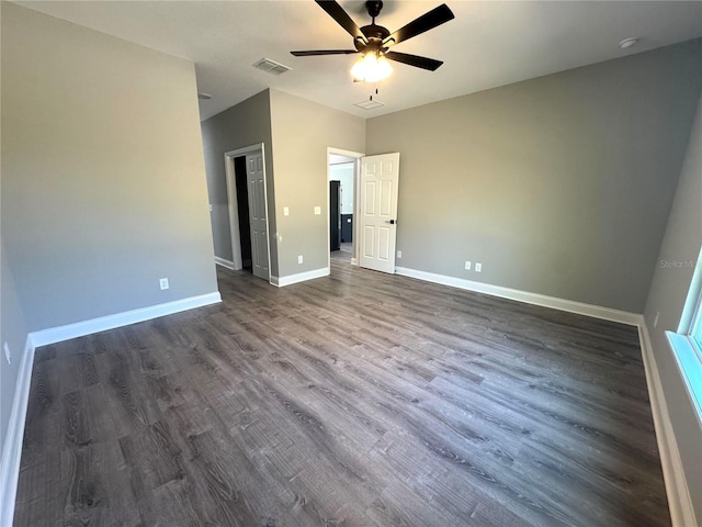 unfurnished bedroom with baseboards, visible vents, dark wood-style flooring, and ceiling fan