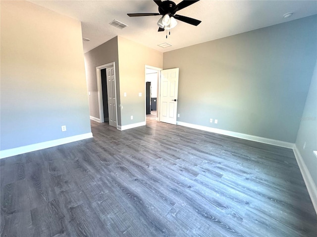 unfurnished bedroom featuring visible vents, baseboards, a ceiling fan, and dark wood-style flooring