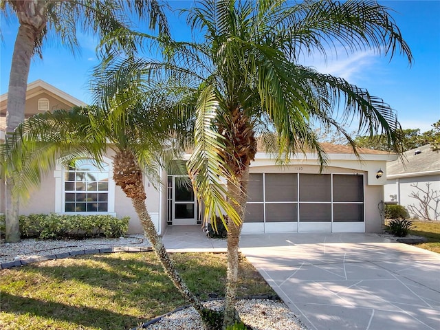 view of front facade with concrete driveway and stucco siding