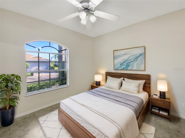 bedroom with a ceiling fan, baseboards, and light tile patterned floors