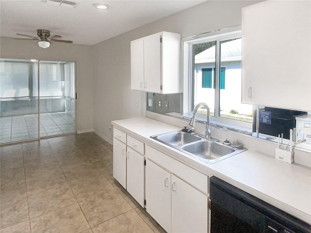 kitchen with light tile patterned floors, white cabinets, dishwasher, light countertops, and a sink