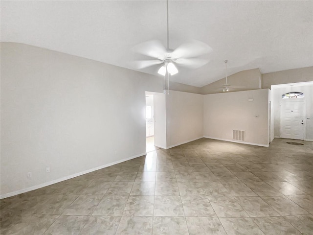 spare room featuring ceiling fan, visible vents, vaulted ceiling, and baseboards