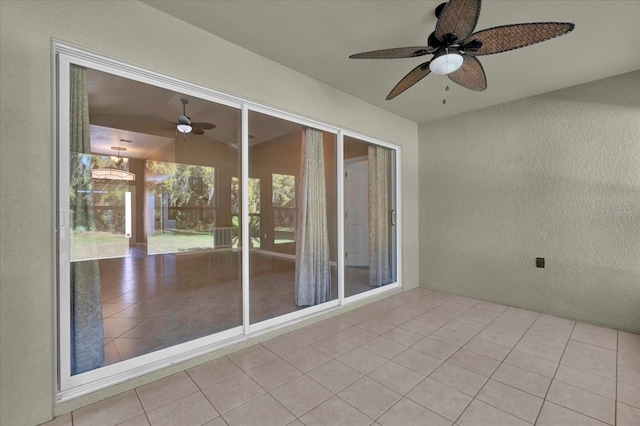 unfurnished sunroom with a ceiling fan