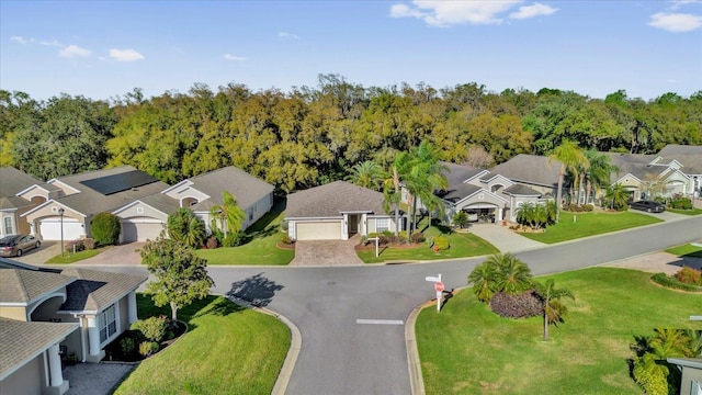 aerial view featuring a forest view and a residential view