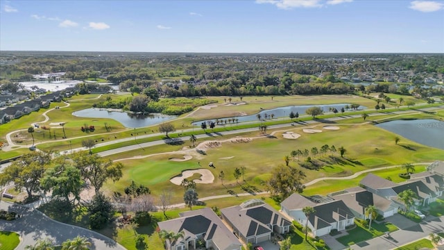 drone / aerial view featuring view of golf course and a water view