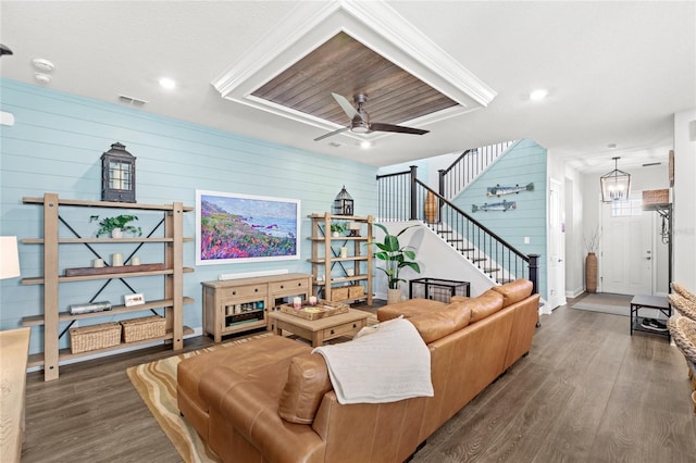 living room featuring stairs, wood finished floors, visible vents, and a ceiling fan