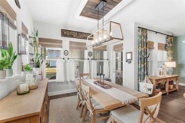 dining space with wood finished floors and baseboards