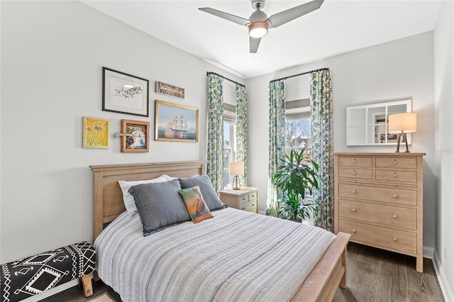 bedroom featuring ceiling fan, dark wood-style flooring, and baseboards