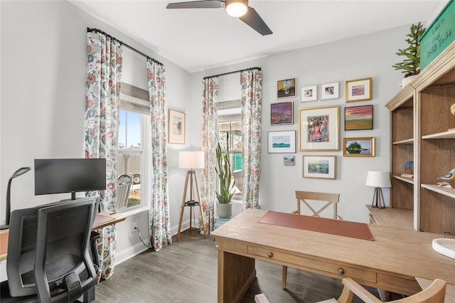 office area featuring ceiling fan, baseboards, and wood finished floors