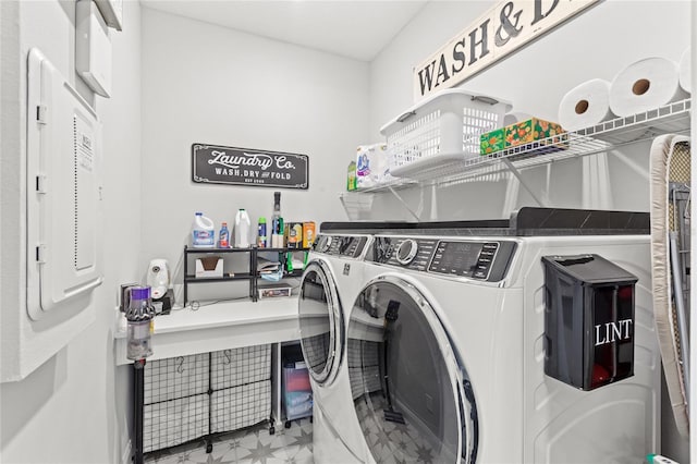 washroom featuring laundry area, washing machine and clothes dryer, and tile patterned floors