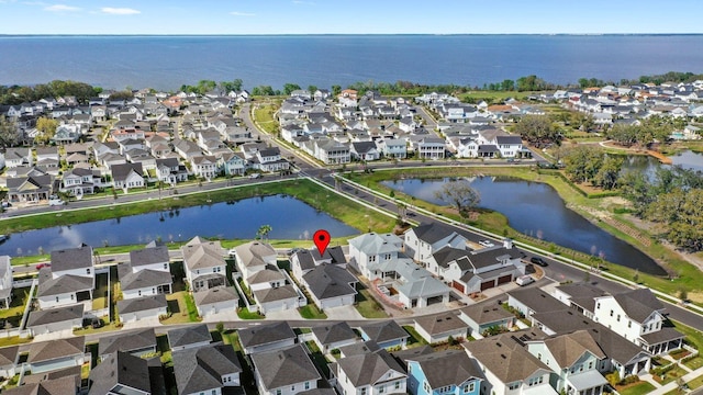 birds eye view of property with a water view and a residential view