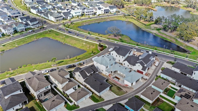 drone / aerial view with a residential view and a water view