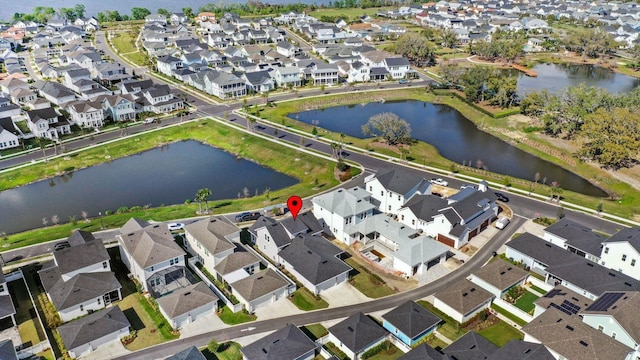 birds eye view of property featuring a residential view and a water view