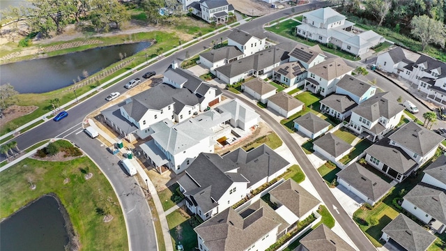 birds eye view of property with a water view and a residential view