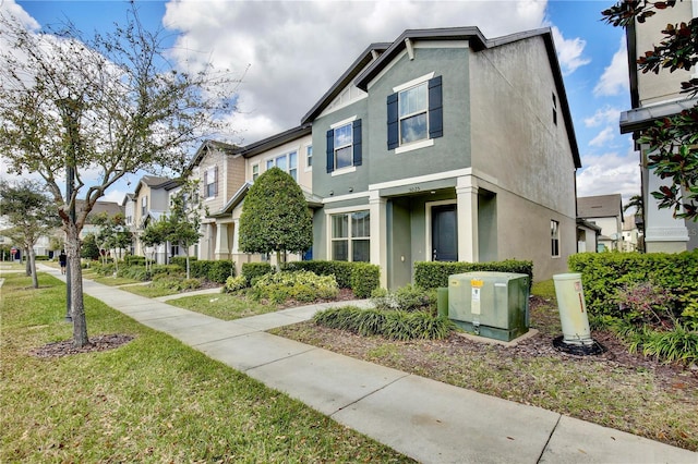 view of home's exterior featuring a yard, a residential view, and stucco siding