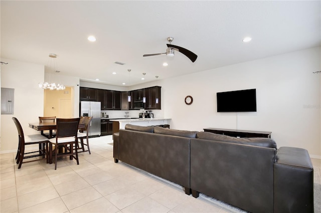 living room featuring ceiling fan, light tile patterned flooring, recessed lighting, visible vents, and electric panel