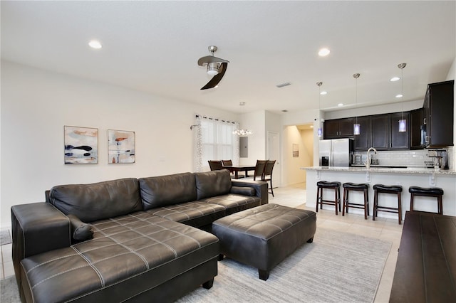 living area with light tile patterned flooring, visible vents, and recessed lighting