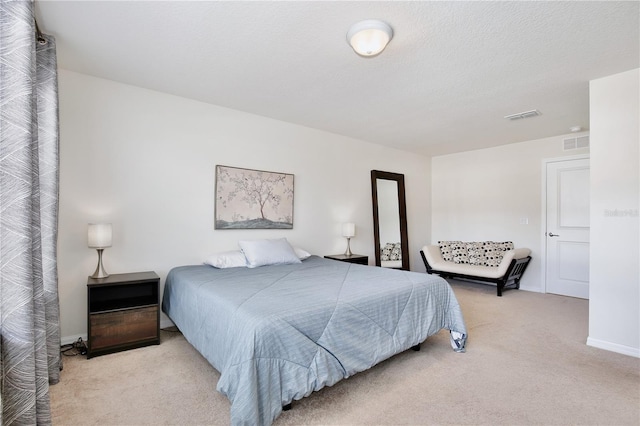 bedroom featuring carpet, visible vents, a textured ceiling, and baseboards