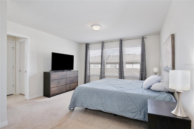 carpeted bedroom featuring baseboards