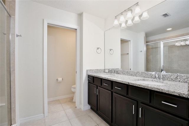 full bathroom with tile patterned flooring, toilet, a sink, visible vents, and a shower stall