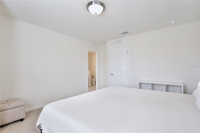 bedroom featuring light carpet, visible vents, and baseboards