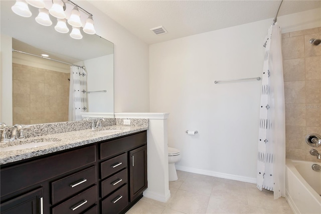 bathroom with toilet, visible vents, a sink, and tile patterned floors