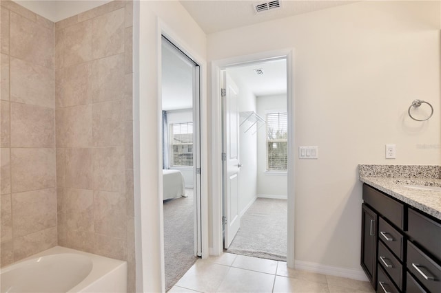 ensuite bathroom with visible vents, ensuite bath, tile patterned flooring, a bathtub, and vanity