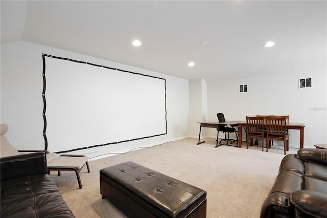 cinema room featuring light carpet, visible vents, vaulted ceiling, and recessed lighting