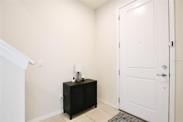 doorway to outside with light tile patterned floors and baseboards