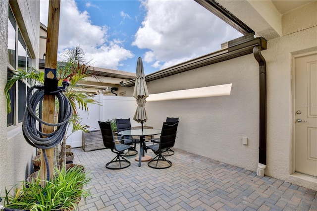 view of patio featuring fence and outdoor dining space