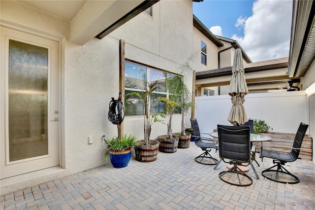 view of patio featuring fence and outdoor dining area