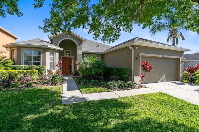 single story home featuring a front lawn, concrete driveway, an attached garage, and stucco siding